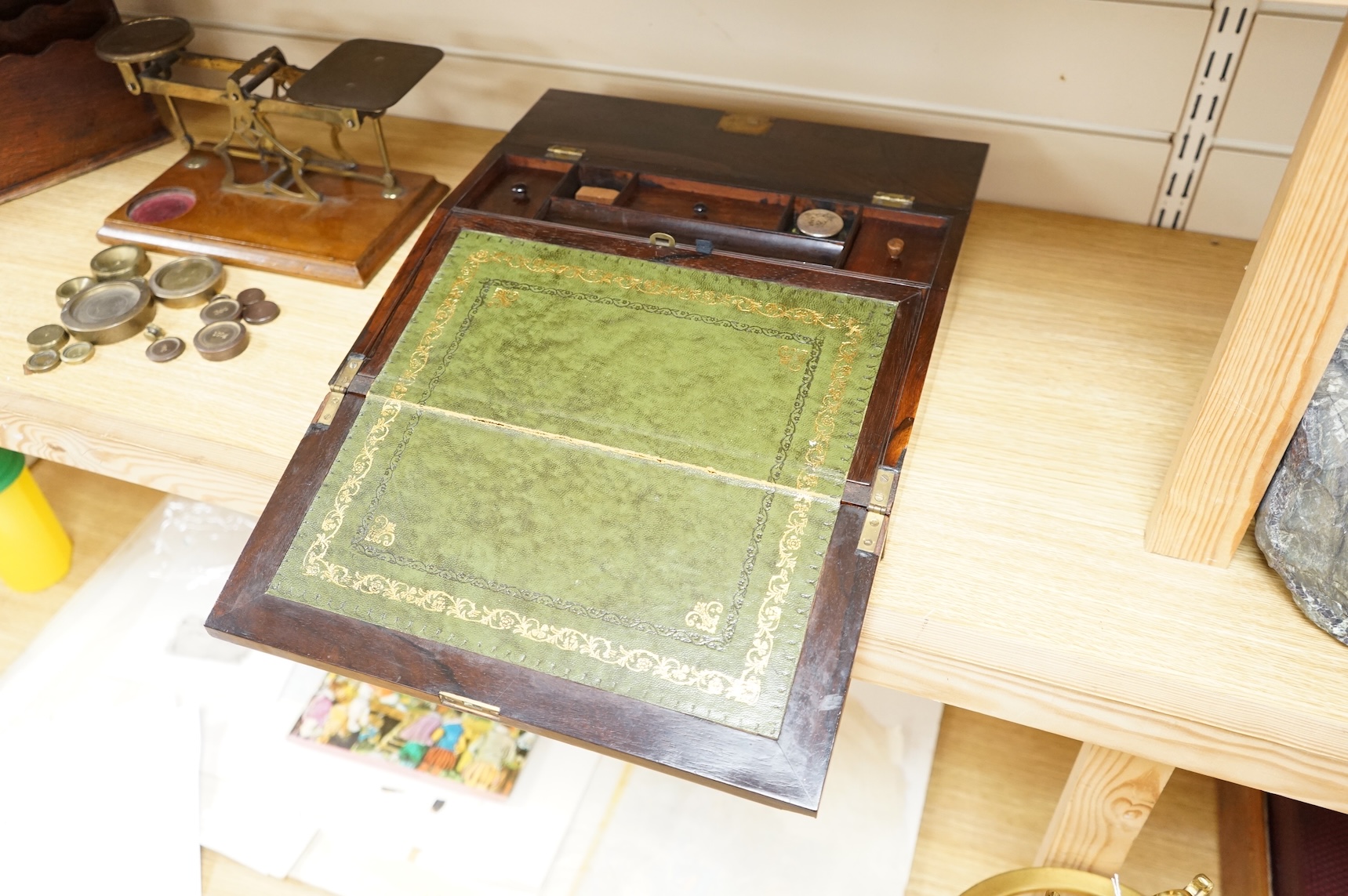 A tooled leather writing slope, a letter rack and postage scales, largest 37cm wide